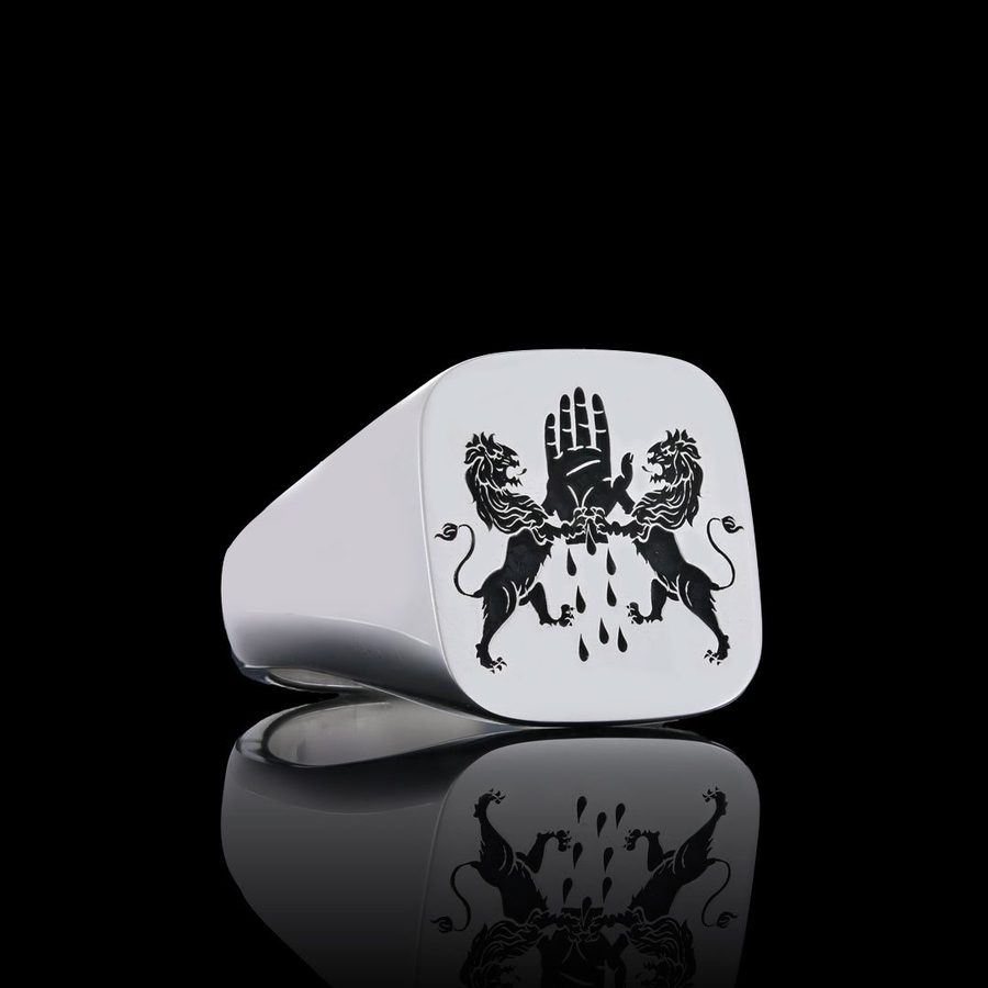 Silver cushion-shaped signet ring engraved with two lions supporting an open hand