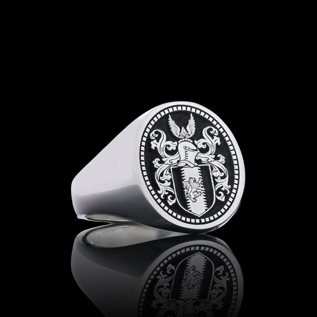 Silver oval signet ring engraved with a full coat of arms, helm and mantling, inside a rope border